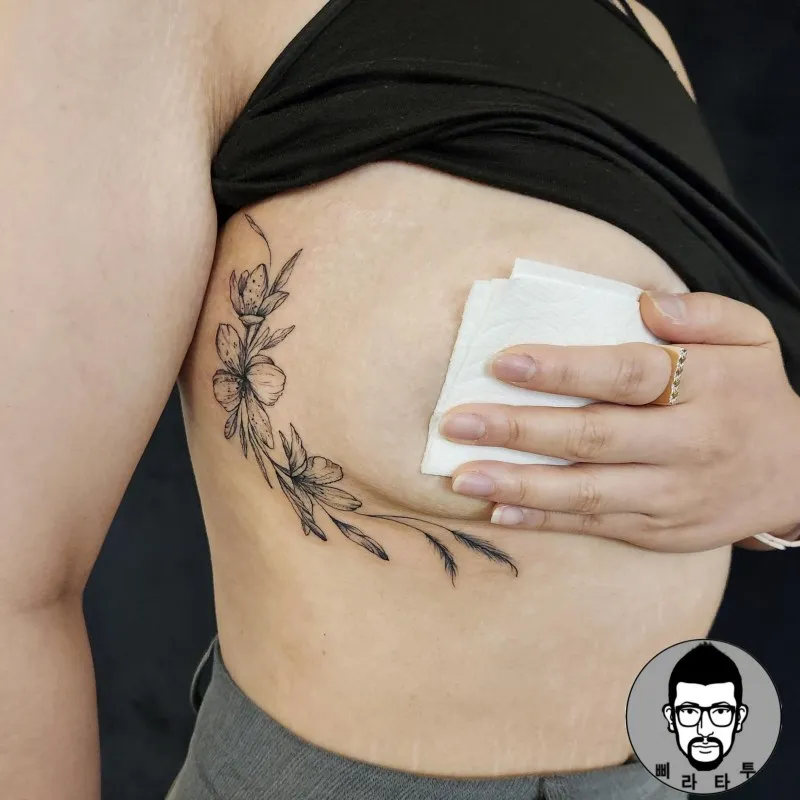 언더브레스트 꽃 타투 — 갈비뼈 아래 라인워크 벚꽃